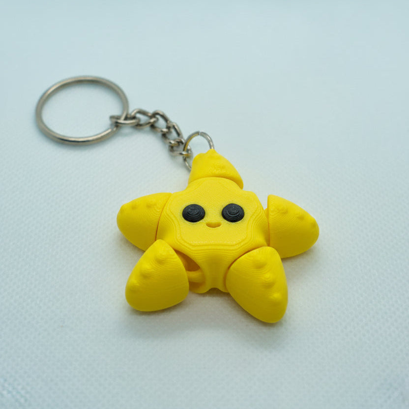 Yellow star-shaped keychain on a white background