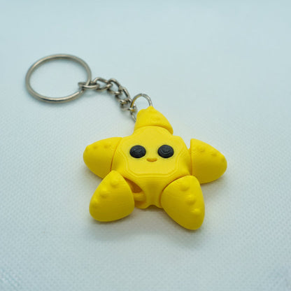 Yellow star-shaped keychain on a white background