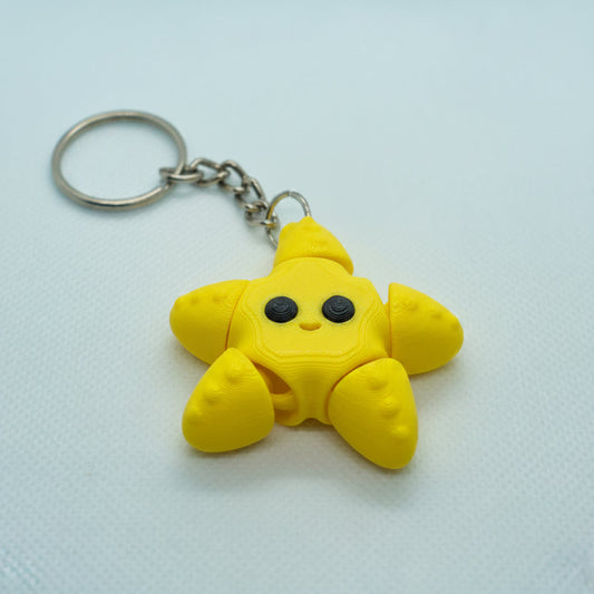 Yellow star-shaped keychain on a white background