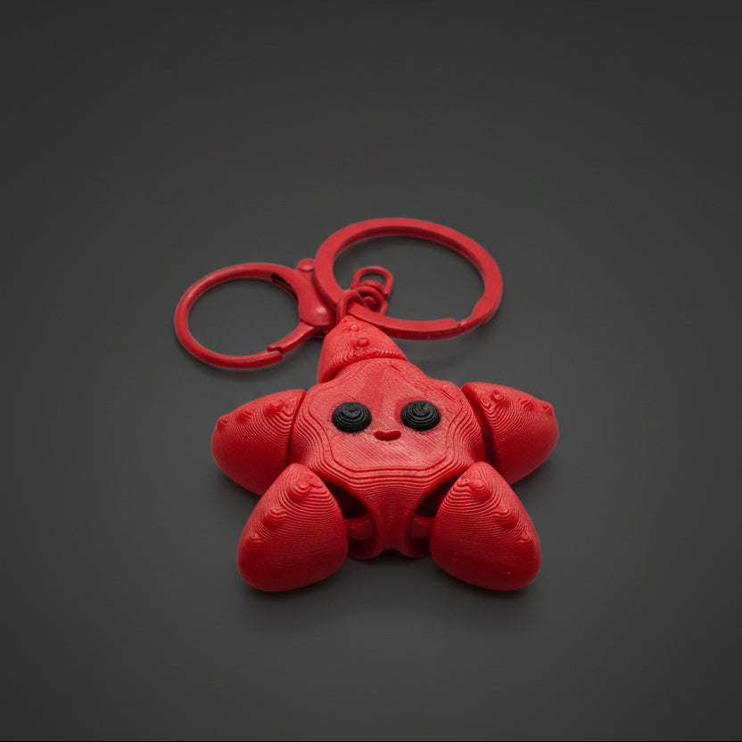 Red star fish shaped keychain on a light gray background