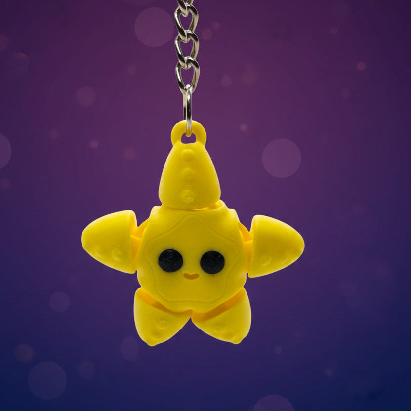 Yellow star-shaped keychain with a chain on a purple and blue gradient background