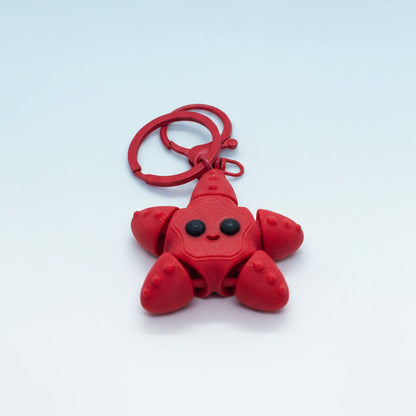 Red star-fish shaped keychain on a white background