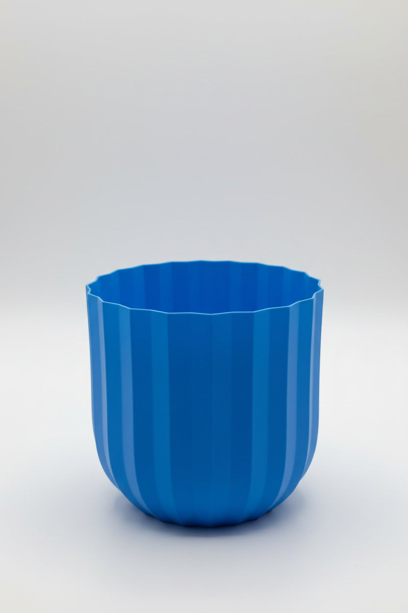 Blue cylindrical object attached to a white appliance with a blurred background